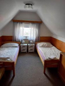 Postel nebo postele na pokoji v ubytování RESTAURACE A PENZION MÁJA