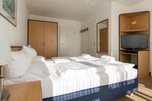 Postel nebo postele na pokoji v ubytování Strandhotel Bansiner Hof