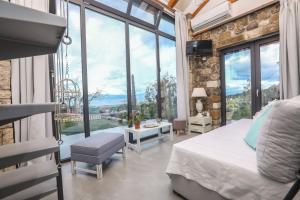 a bedroom with a bed and a large window at Casa Pietra in Kontokali