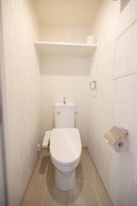 a small bathroom with a white toilet in a room at Seiryu Tsutenkaku in Osaka