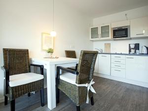 a kitchen with a table and chairs in a kitchen at Residenz am Balmer See - BS 55 mit Wellnessbereich in Balm