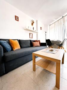 a living room with a couch and a coffee table at TwinTorres LasAmericas in Playa de las Americas