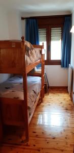 a bedroom with two bunk beds and a window at APARTMENT NATURA in Puigcerdà