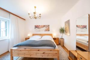a bedroom with two beds and a chandelier at Ferienhaus Zur alten Mühle in Tamsweg