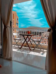 a balcony with a table and chairs on a balcony at TwinTorres LasAmericas in Playa de las Americas