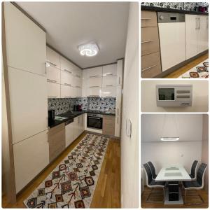 a kitchen with white cabinets and a table and a rug at Sarajevo Apartment in Sarajevo