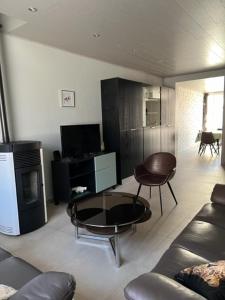 a living room with a couch and a table at MORI in Bruges