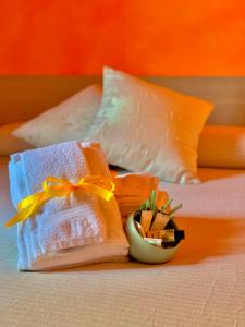 a bed with towels and a plant on it at Acquamarina in Gaeta