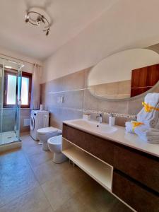 a bathroom with a sink and a toilet and a mirror at Acquamarina in Gaeta