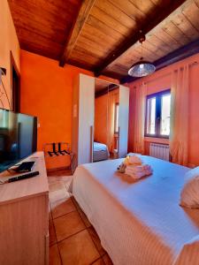 a bedroom with a bed and a flat screen tv at Acquamarina in Gaeta +30 photos