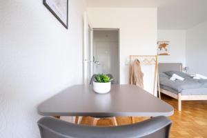 a table and a chair in a room with a bed at Studioapartment mit Küche und großem Balkon in Flensburg