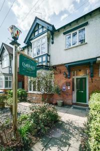 a street sign in front of a house at Emerald Stays UK at The Adelphi in Stratford-upon-Avon