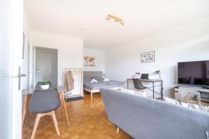 a living room with a couch and a tv at Studioapartment mit Küche und großem Balkon in Flensburg