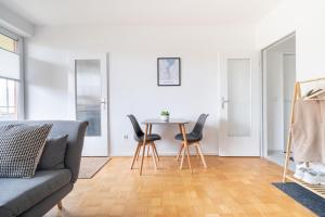a living room with a table and chairs at Studioapartment mit Küche und großem Balkon in Flensburg