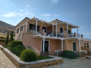 a large house with a balcony on top of it at Captains View Apartments in Platy