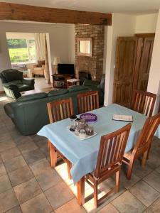 a living room with a table and a couch at Bainvalley Cottages peaceful South Cottage in Lincolnshire