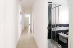 a bathroom with a glass shower and a sink at Appartamenti Gherbin in Lido di Jesolo