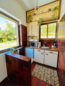 a kitchen with a large window and a counter top at Gazonia Family Estate in Skala Kefalonias