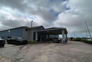 a car dealership with cars parked in a parking lot at Super 8 by Wyndham Lake Charles/Sulphur in Lake Charles