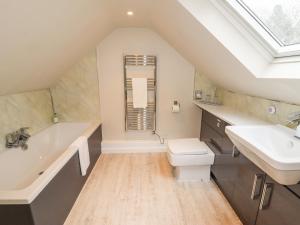 a bathroom with a sink and a tub and a toilet at Lee House Cottage in Cheddleton +51 photos