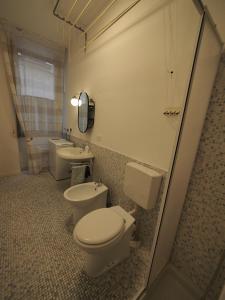 a bathroom with two toilets and a sink and a mirror at From Pedrotti in Desenzano del Garda