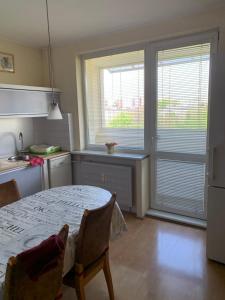 a kitchen with a table and two windows at Apartment BU15 in Trnava