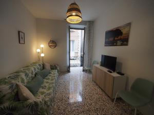 a living room with a couch and a television at From Pedrotti in Desenzano del Garda