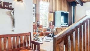 a living room with a staircase and a dining room at Mammoth West #140 Condo in Mammoth Lakes