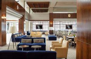 a lobby with couches and chairs and a waiting room at Hyatt Regency Lisle near Naperville in Lisle