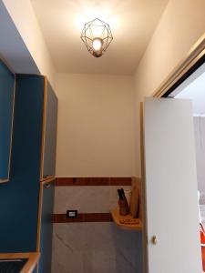 a bathroom with a shower with a light on the ceiling at La casa di Max in La Spezia +10 photos