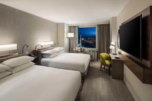 a hotel room with two beds and a flat screen tv at Hyatt Regency Portland at the Oregon Convention Center in Portland