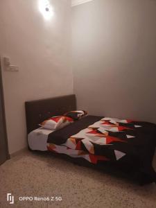 a bedroom with a bed with a colorful quilt at Pantai Dickson Stay 3838 with Private Pool in Port Dickson +13 photos