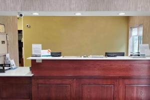 a reception desk with a large mirror on the wall at Wingate by Wyndham Uniontown in Uniontown