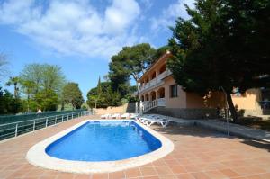 a swimming pool in front of a house at Museu Baixos in L'Escala