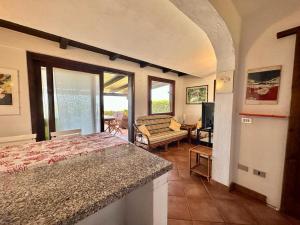 a bedroom with a bed and a living room at Residence Domos De Rocca in Monte Petrosu