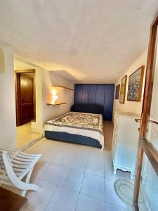 a bedroom with a bed with a blue head board at Residence Domos De Rocca in Monte Petrosu