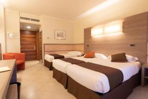 Postel nebo postele na pokoji v ubytování NilHotel Florence