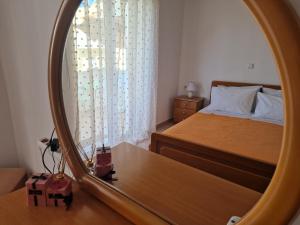 a bedroom with a bed and a mirror at Apartment in Tigaki beach Kos in Tigaki