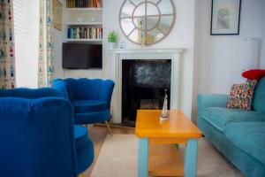 a living room with blue chairs and a fireplace at Jewel Pier *2 Bed House* Deal in Deal