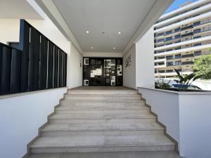 a hallway with stairs leading to a building at Praia da Rocha Modern by Homing in Praia da Rocha