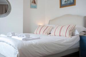 a white bed with towels on top of it at Jewel Pier *2 Bed House* Deal in Deal