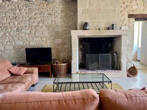 a living room with two couches and a fireplace at Villa de charme tourangelle in Vallères +22 photos