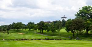 a group of people on a golf course at Ponderosa Golf & Country Resort in Johor Bahru