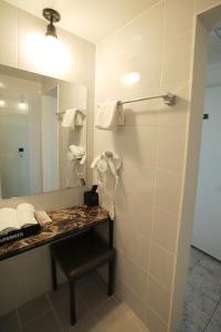 a bathroom with a vanity with a mirror and a sink at Stay RomanticTrip_Hostel in Gyeongju
