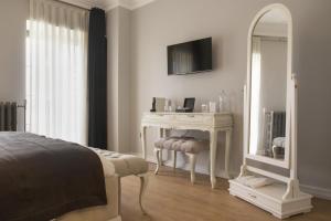a bedroom with a dressing table and a mirror at Louis Rooms in Istanbul