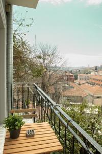 a balcony with a bench and a view of a city at Louis Rooms in Istanbul