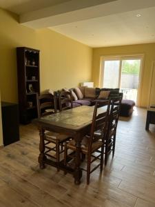 a living room with a table and chairs and a couch at wante 22 in Bruges +1 photo
