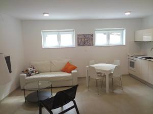 a living room with a couch and a table at Drance Apartments in Selce