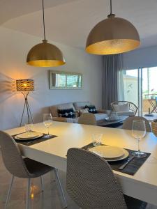 a dining room with a table and chairs with wine glasses at New refurnished Apartment Elviria Hills Marbella in Marbella