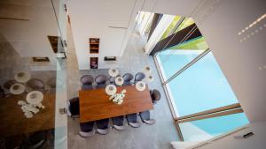 an overhead view of a dining room with a table and chairs at A modern villa in Zmijavci with a gym, tennis and basketball court in Zmijavci +14 photos